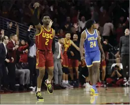  ?? MARCIO JOSE SANCHEZ — ASSOCIATED PRESS ?? USC’S Jonah Mathews (2) runs back after making a game-winning 3-point basket over UCLA forward Jalen Hill as time expired. He said the shot will “stick with them forever.”