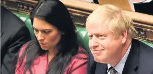  ??  ?? SOLIDARITY Priti Patel was defended by Boris Johnson, who sat next to her in the Commons