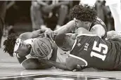  ?? Ron Jenkins / Associated Press ?? TCU’s RJ Nembhard, left, Texas A&M’s Jonathan Aku (15), and Andre Gordon battle for a loose ball.