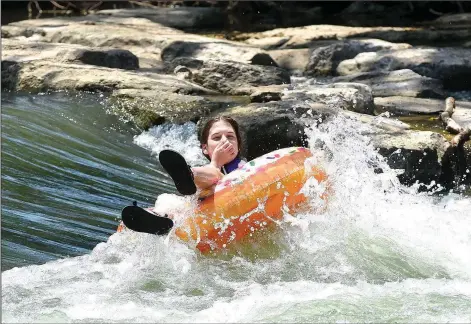  ?? NWA Democrat-Gazette/FLIP PUTTHOFF ?? A youngster tests a wave at the Siloam Springs Kayak Park on the Illinois River. The park offers a cool summertime oasis