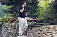  ?? ASSOCIATED PRESS ?? Gov. Andrew Cuomo talks on the phone while walking with his dog Captain at the New York state Executive Mansion, Saturday, Aug. 7, 2021, in Albany, N.Y. An investigat­ion found that Cuomo sexually harassed multiple women in and out of state government.