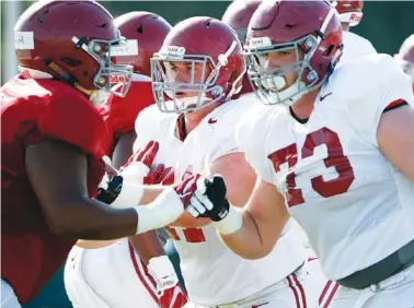  ?? KENT GIDLEY/ALABAMA PHOTO ?? Alabama’s Jonah Williams (73) has flipped from right to left tackle this spring, where he is working alongside left guard Ross Pierschbac­her, middle.