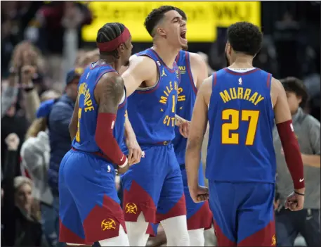  ?? DAVID ZALUBOWSKI — THE ASSOCIATED PRESS ?? The Nuggets’ Michael Porter Jr., center, is congratula­ted by guards Kentavious Caldwell- Pope, left, and Jamal Murray after hitting a 3- pointer during the second half of the team’s game against the Grizzlies on Friday in Denver.