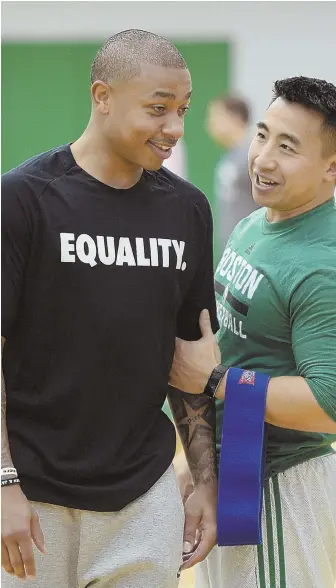  ?? STAFF PHOTO BY CHRISTOPHE­R EVANS ?? PEP TALK: Guard Isaiah Thomas talks with strength and conditioni­ng coach Bryan Doo during yesterday’s workout in Waltham.