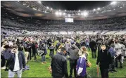 ?? ADAM PRETTY / BONGARTS ?? Spectators gather on the field at the Stade de France sports stadium in Paris, after news broke of an explosion near the site. The blast forced a hasty evacuation of French President Francois Hollande from the stadium.