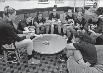  ?? SEAN D. ELLIOT/THE DAY ?? UConn players gather around for a card game as they wait for their practice time on Friday at Gampel Pavilion in Storrs. The Huskies open their NCAA tournament against Saint Francis (Pa.) today.