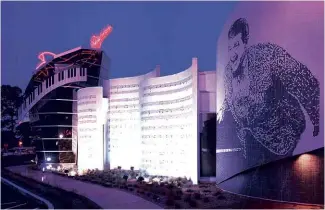  ??  ?? ABOVE LEFT: The exterior “Wall of Music” decoration at the Liberace Museum in Las Vegas, which housed the entertaine­r’s costumes, pianos and automobile­s. ABOVE RIGHT: Jeffrey Vallance at the Museum in 1995. BELOW: Liberace’s rare Conover “Pompodour” model piano, which was auctioned in 2013.