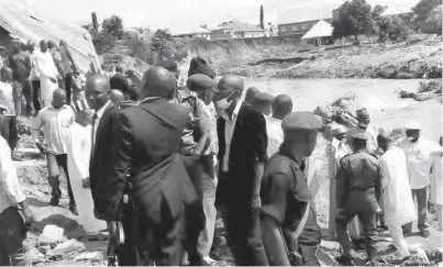  ?? PHOTO: ?? Governor Umaru Tanko Al-Makura of Nasarawa State (2nd right) with government officials, during a visit to the scene of Monday’s flood disaster that claimed six lives and destroyed 38 houses in New Karu layout of the state yesterday Abbas Jimoh From...