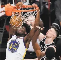  ?? Kathy Willens / Associated Press ?? Warriors center James Wiseman dunks in front of Brooklyn forward Rodions Kurucs in the second half.