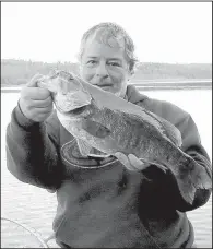  ?? Special to the Democrat-Gazette/AMY HENDRICKS ?? Arkansas Democrat-Gazette outdoors writer Bryan Hendricks (left) caught his three biggest smallmouth bass ever last week at the Boundary Waters Canoe Area Wilderness in northern Minnesota. The biggest was close to 5 pounds. Also making the trip was...