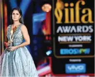  ??  ?? Bollywood Actress Katrina Kaif holds a trophy on stage.