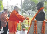  ??  ?? Chief minister Yogi Adityanath garlanding the idol of Babasaheb ▪
Bhimrao Ambedkar at BBAU on Wednesday.