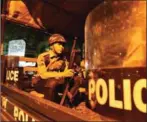  ?? MYO MIN SOE/AFP ?? A Myanmar riot policemen sits in a truck on a street in Yangon’s Mingalar Taung Nyunt township early yesterday.