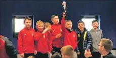  ??  ?? Arran United players proudly hoist one of their trophies into the air at the prize giving ceremony.