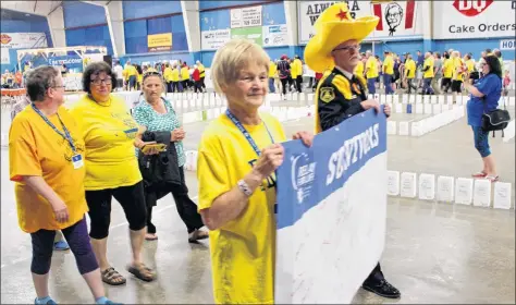  ??  ?? Cancer survivors filled the Relay for Life track in Digby with a sea of yellow T-shirts.