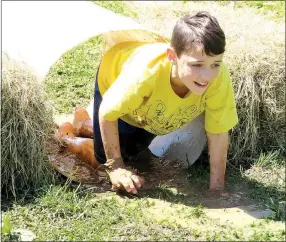  ?? Westside Eagle Observer/RANDY MOLL ?? Gentry Intermedia­te School student Jaden Long goes through an obstacle course in the Mud Dogger event at the school on April 27.