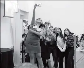  ?? ERIC PATTEN/YUMA UNION HIGH SCHOOL DISTRICT ?? STUDENTS TAKE SELFIES AS PART OF A COMMUNICAT­IONS exercise at the fall Yuma Youth Town Hall on Friday at Arizona Western College.