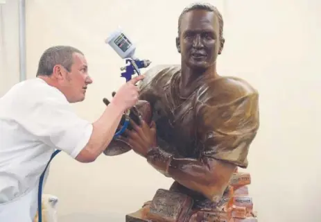  ?? Denver Post file ?? Anyone who’s seen the massive chocolate sculptures created by chefs David Lewis and Gonzo Jimenez has most certainly fallen in love at first sight. Here, Lewis — a chef at Miette et Chocolat of Denver — works on a chocolate Peyton Manning in 2015.