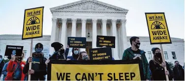  ?? Agence France-presse ?? ↑
A small group of demonstrat­ors protests outside the US Supreme Court in Washington on Monday.