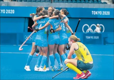  ??  ?? India players celebrate after defeating Australia in their Tokyo Olympic women’s hockey quarter-final at the Oi Hockey Stadium in Tokyo on Monday.