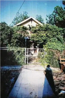  ??  ?? Mary Cerruti’s shadow looms in a photo she took at her home at 610 Allston. It is expected to take months to identify the remains found there by new residents.