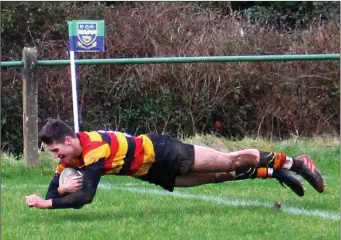  ??  ?? Euan Brown dives over the line for his second try of the game. Pic: Jean McConnell.