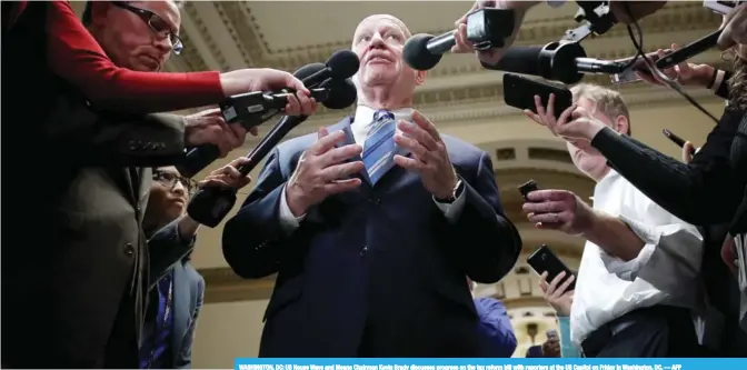  ??  ?? WASHINGTON, DC: US House Ways and Means Chairman Kevin Brady discusses progress on the tax reform bill with reporters at the US Capitol on Friday in Washington, DC.