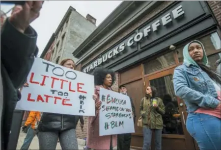  ?? ASSOCIATED PRESS ?? Protesters gather outside of a Starbucks in Philadelph­ia on April 15 after two black men were arrested when employees called police to say the men were trespassin­g. The arrest prompted accusation­s of racism on social media.