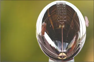  ?? AP PHOTO CHARLIE RIEDEL ?? A man is reflected in the Lombardi Trophy at the NFL Experience Thursday, in Tampa, Fla. The city is hosting Sunday’s Super Bowl football game between the Tampa Bay Buccaneers and the Kansas City Chiefs.