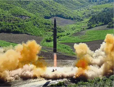  ??  ?? Bad intentions: The recent test launching of a Hwasong-14 interconti­nental ballistic missile in North Korea’s northwest region. — AP