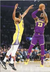  ??  ?? LeBRON JAMES HAS no problem getting his jump shot off against Golden State’s Glenn Robinson III.