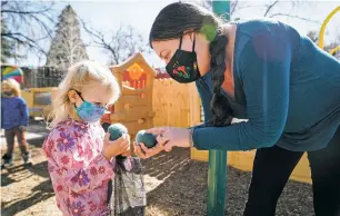  ?? GABRIELA CAMPOS/THE NEW MEXICAN ?? Garcia Street Club executive director Rachel Lee Waldrop and Adeline McCormick pretend that felt balls are dinosaur eggs on one of the four playground­s at the preschool.