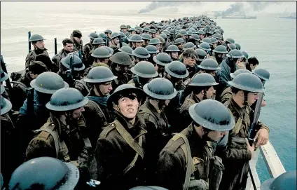  ??  ?? Tommy (Fionn Whitehead, foreground, looking up) is a 19-year-old English private trying to escape the German forces and make it home in Christophe­r Nolan’s Dunkirk.