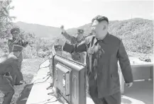  ?? AFP photo / KCNA via KNS ?? Kim Jong Un reacts Tuesday to the test-firing of a missile, in a photo released by the official North Korean news agency. He said the launch was a Fourth of July “gift” to the United States.