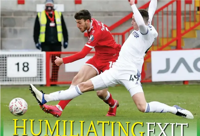  ?? Photo: VCG ?? Crawley Town’s Ashley Nadesan (in red) scores his side’s second goal during the FA Cup third-round match between Crawley Town and Leeds on Sunday in Crawley, England.