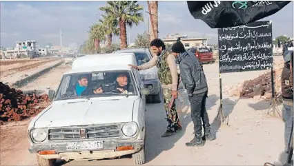  ?? Photo: REUTERS ?? Papers, please: Rebel fighters man a checkpoint in al- Dana in Idlib province after they captured the town from their Islamist rivals.