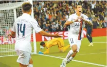  ?? AP-Yonhap ?? PSG’s Angel Di Maria, right, celebrates after scoring his side’s opening goal during the Champions League group A soccer match between PSG and Real Madrid in Paris, Wednesday.