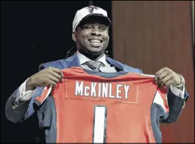  ?? ELSA / GETTY IMAGES ?? Takkarist McKinley of UCLA reacts after going to the Falcons in the draft. The Falcons gave up a third-round and a seventh-round pick to Seattle to move up from the 31st spot.