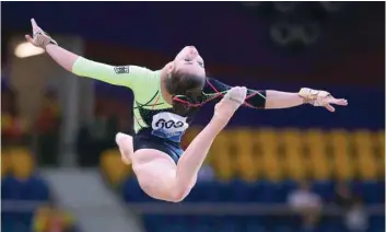  ?? — AFP ?? Leah Griesser of Germany competes on the floor during women’s team final of the 2018 FIG Artistic Gymnastics in Doha.