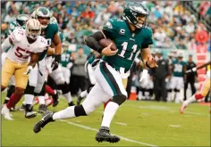  ?? AP PHOTO / CHRIS SZAGOLA ?? Philadelph­ia Eagles quarterbac­k Carson Wentz (11) runs the ball during the first half of an NFL football game against the San Francisco 49ers, Sunday in Philadelph­ia.