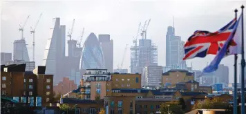  ??  ?? A Union flag flies from a pole, with the City of London in the background, as Britain and the EU seek to overcome difference­s over the country’s so called divorce bill. (AFP)