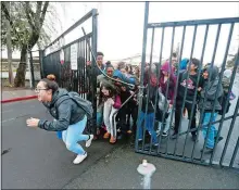  ?? ARIC CRABB/EAST BAY TIMES VIA AP ?? Students from Mount Diablo High School break through a gate to leave campus during a walkout to protest gun violence Wednesday in Concord, Calif.