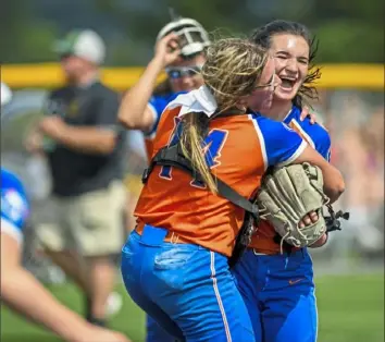 ?? Steve Mellon/Post-Gazette ?? Armstrong catcher Isabella Atherton (14) embraces pitcher Cameryn Sprankle after their team defeated Penn-Trafford, 3-2, in a PIAA Class 5A semifinal Monday at Mars.