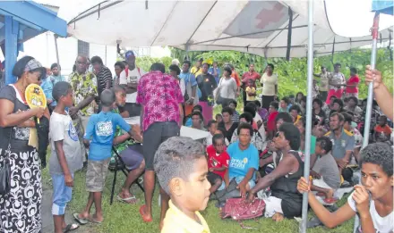  ?? Photo: Lusiana Tuimaisala ?? Recipients receiving their vouchers outside the Foundation Education for the Needy Children (FENC) head office in Suva on January 11, 2018.