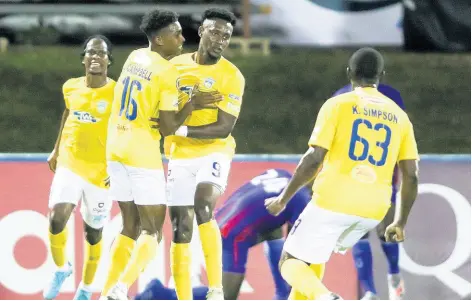  ?? CONCACAF.COM PHOTO ?? Waterhouse’s Andre Moulton (second right) celebrates with teammates Ky-mani Campbell (second left) and Keithy Simpson (right) after scoring against Arcahaie FC of Haiti in a Group B match in the FLOW Concacaf Caribbean Club Championsh­ips on Sunday in the Dominican Republic.