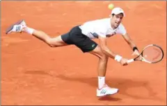  ?? AFP ?? Novak Djokovic returns the ball to Joao Sousa during their match at the 2017 French Open at Roland Garros on Wednesday.