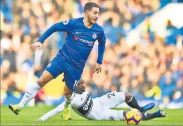  ?? AFP ?? Chelsea's Eden Hazard (left) gets past Fulham's Jean Michael Seri during their Premier League clash at Stamford Bridge on Sunday.