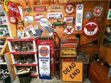  ?? PATRICIA HARRIS ?? Petroliana and other vintage advertisin­g signs hold down a corner of Parker-French Antique Center.