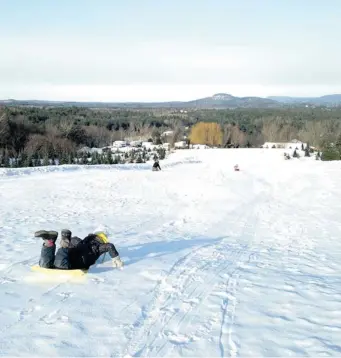  ?? PHOTOS: ANDY RIGA/ THE GAZETTE ?? Bring your own toboggan or rent tubes for sliding at Sharp Park, in Milton, Vt.