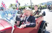  ?? PHOTO: JOHN COSGROVE ?? A tune for the day . . . Tapanui’s last surviving World War 2 veteran Bill Roulston plays a tune as he takes part in the street parade through Tapanui to commemorat­e the end of World War 1 during a gala street party yesterday.